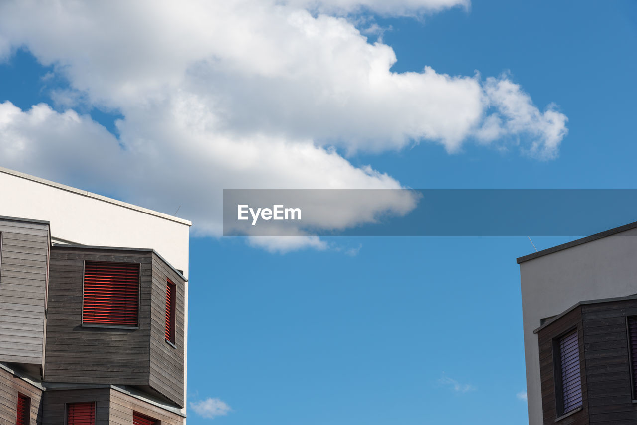 architecture, sky, building exterior, built structure, building, blue, cloud, window, house, city, facade, residential district, low angle view, nature, residential area, no people, day, outdoors, home ownership, industry