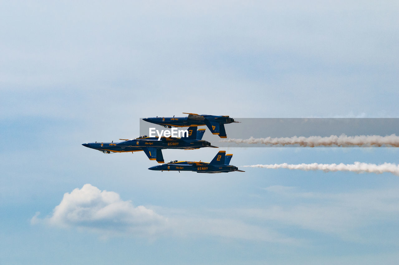 LOW ANGLE VIEW OF AIRSHOW AGAINST SKY