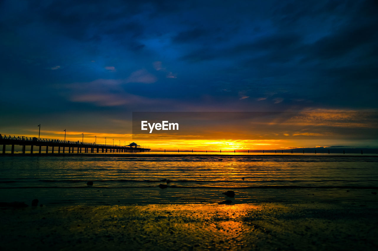 SCENIC VIEW OF SEA AGAINST ORANGE SKY