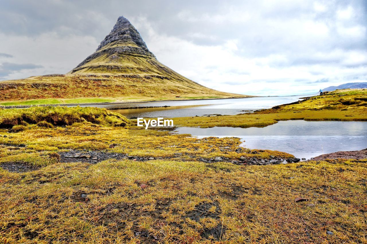 Scenic view of lake against cloudy sky