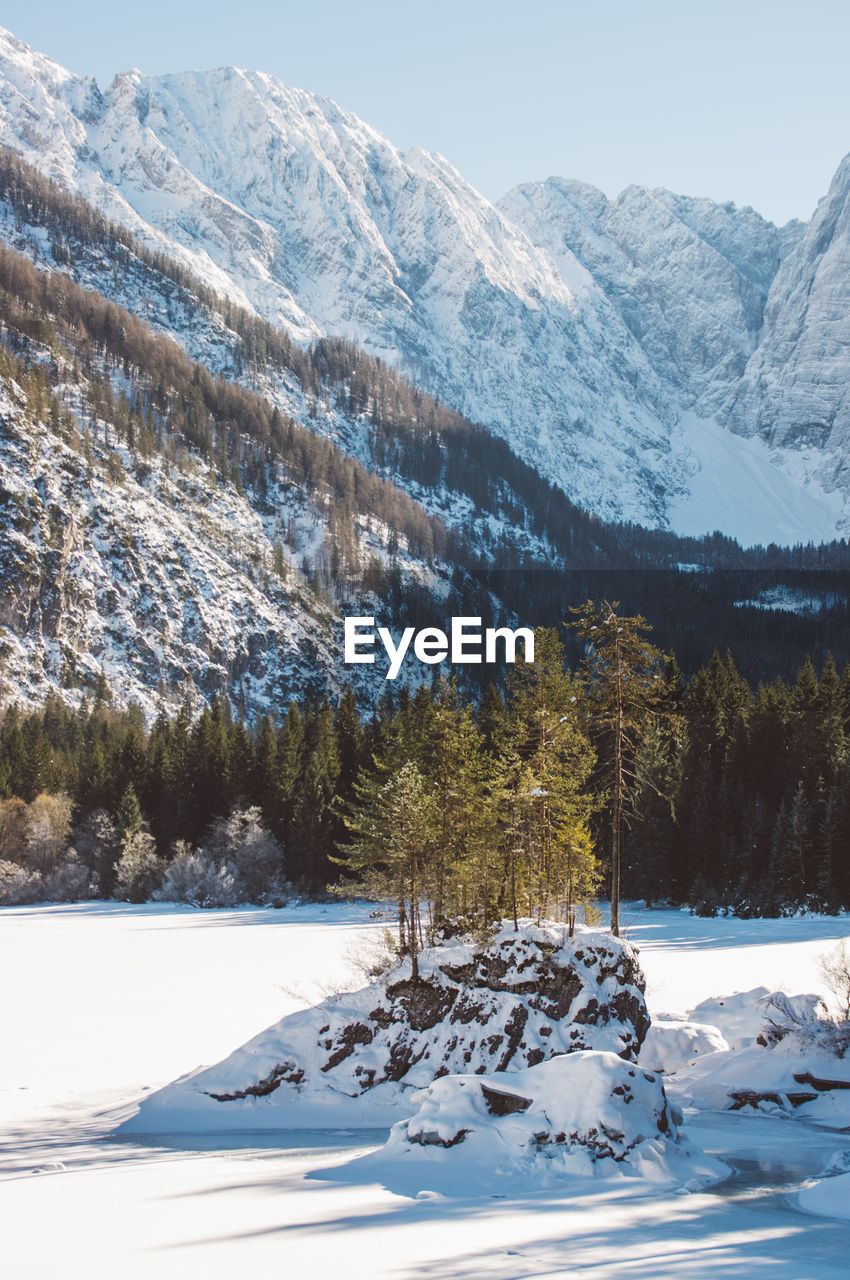 Snow coverd lake and mountains, laghi di fusine in winter