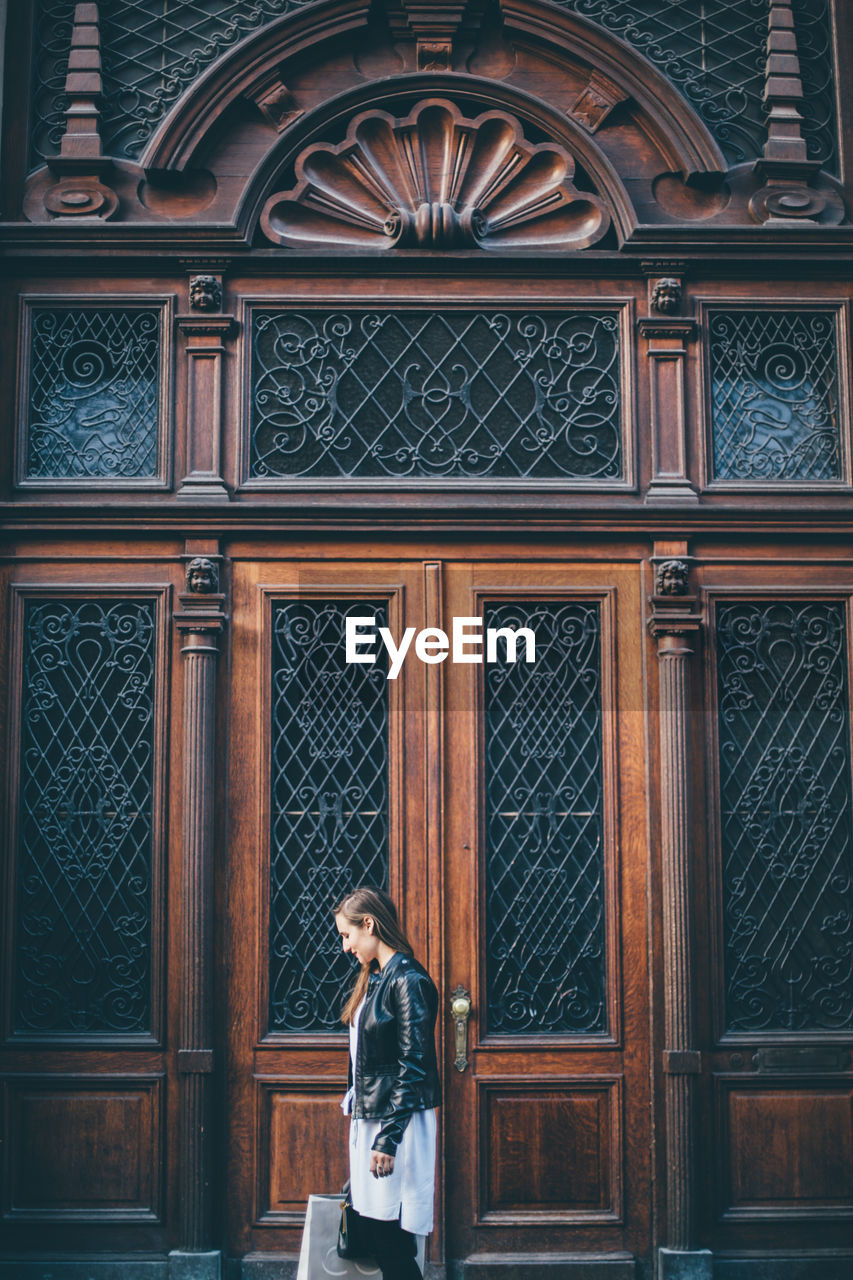 Woman standing at entrance of building