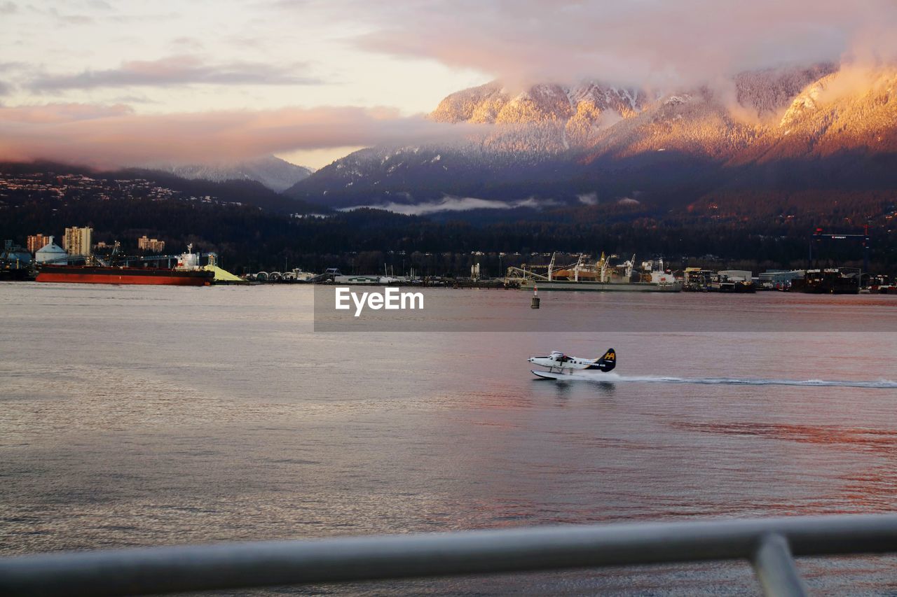 SCENIC VIEW OF LAKE BY MOUNTAINS AGAINST SKY