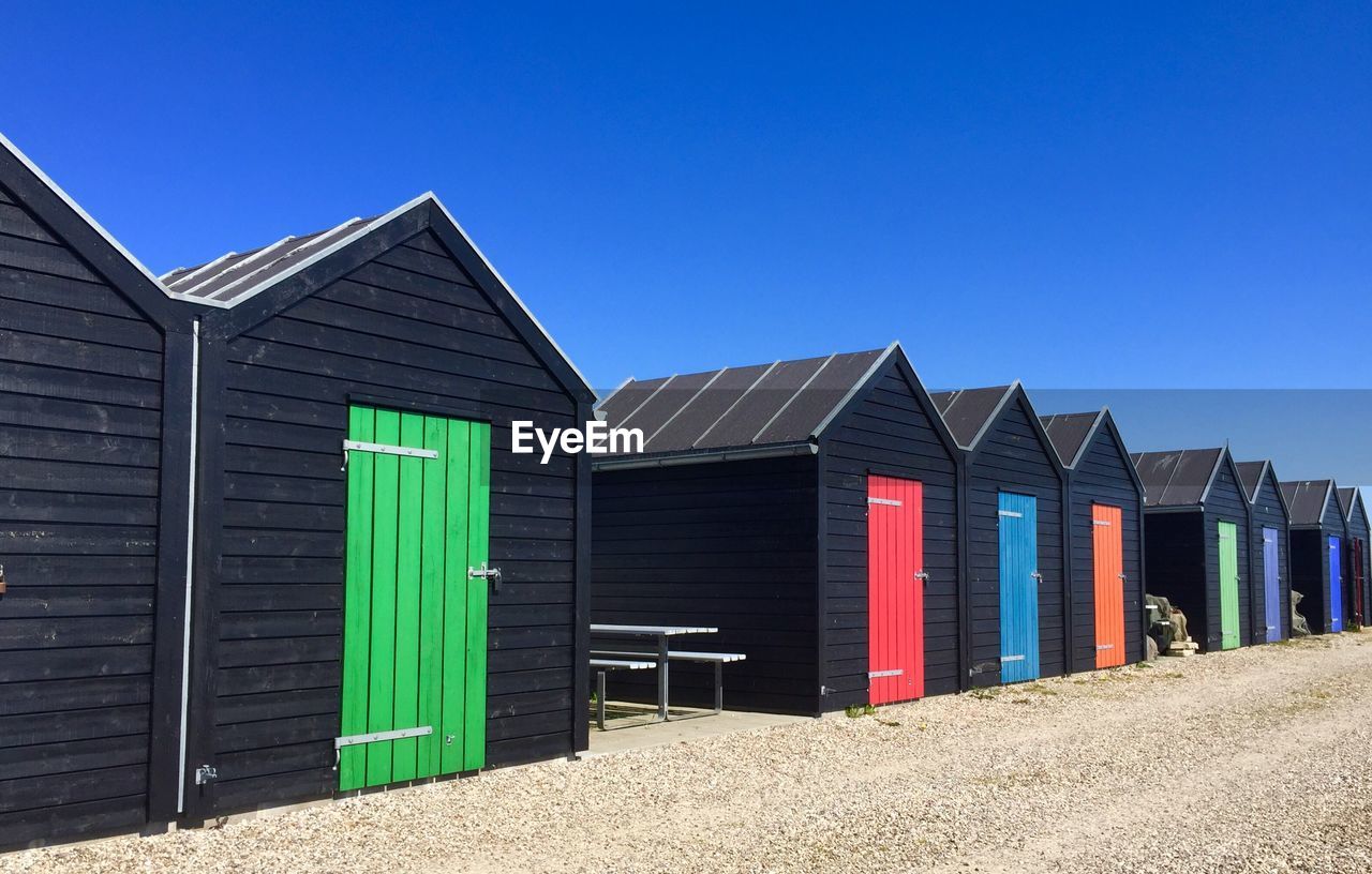 Scenic view of beach huts against clear sky