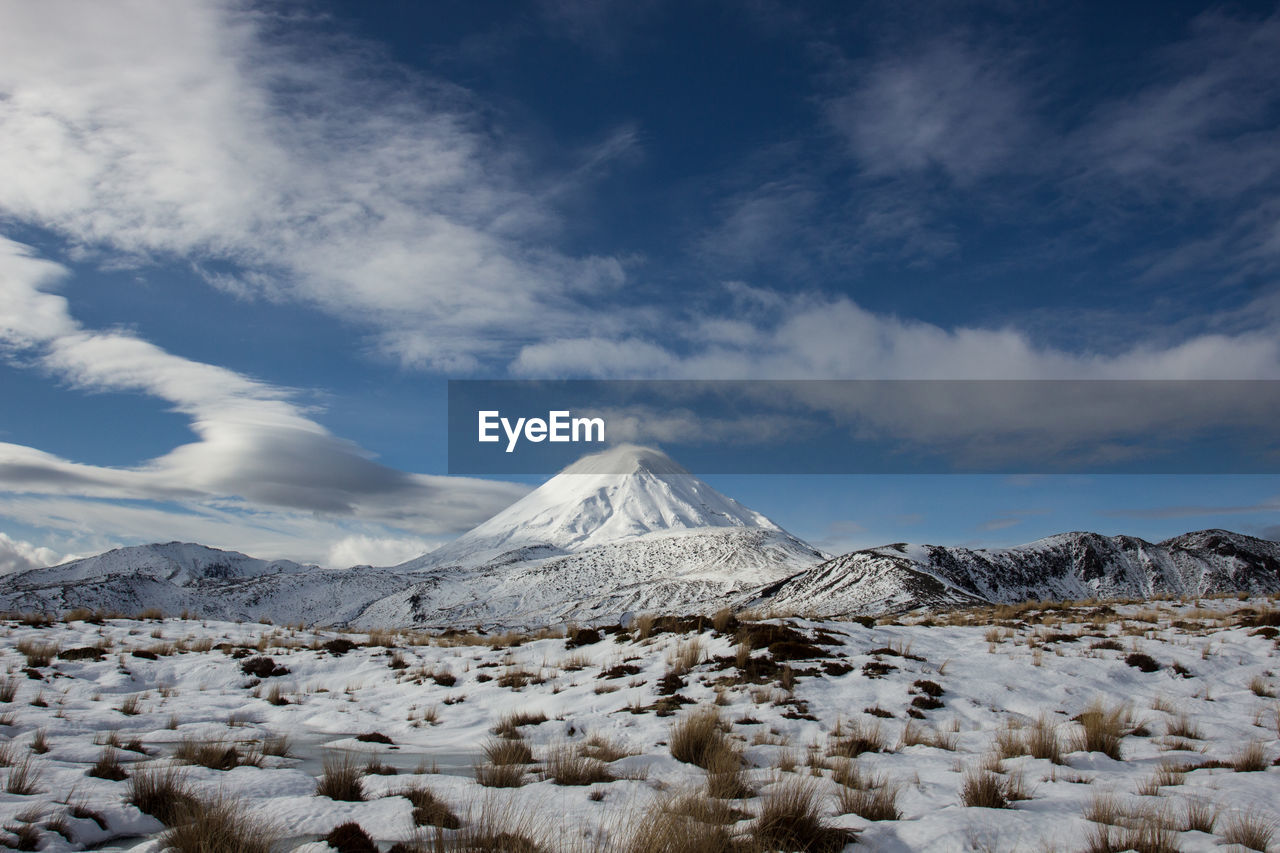 Lenticular clouds beside the snow covered mt ngauruhoe in the tongariro national park