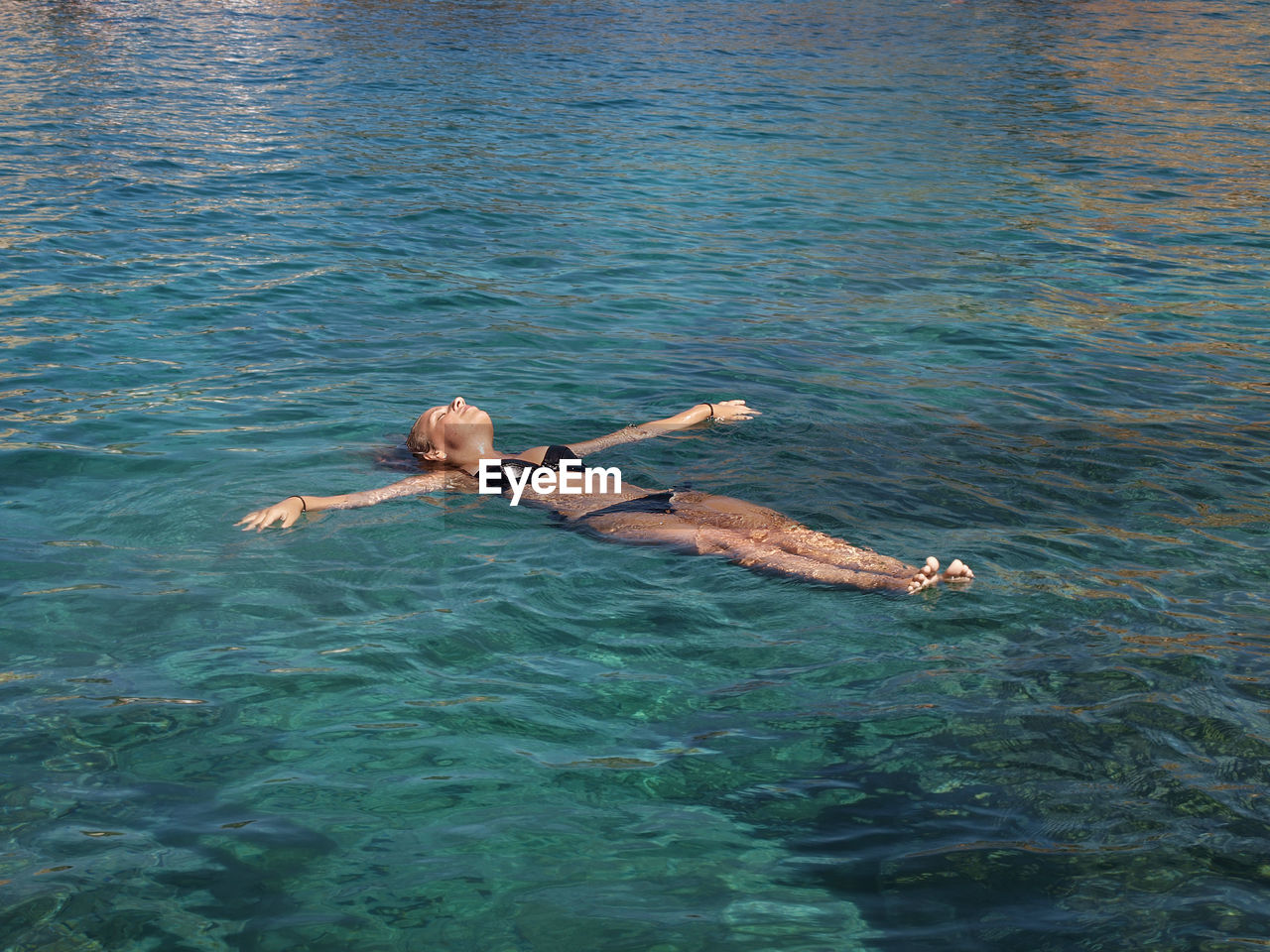 High angle view of woman swimming in sea