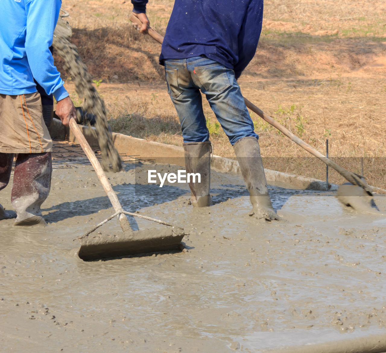 Low section of men working at construction site