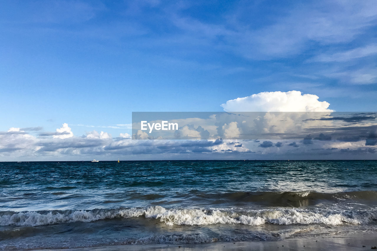 Scenic view of sea against blue sky