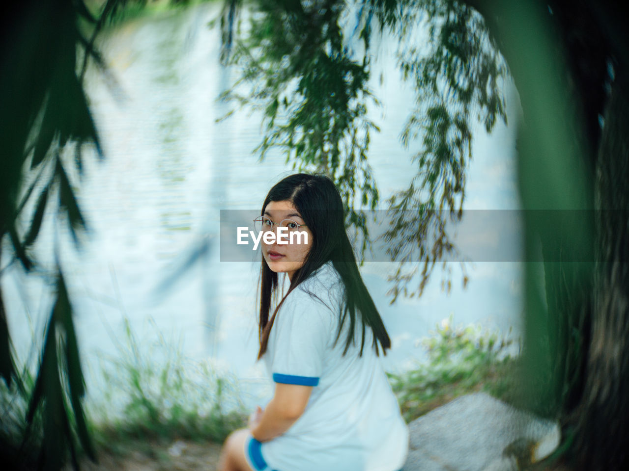 Portrait of woman standing by plants