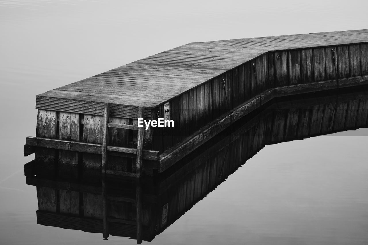 LOW ANGLE VIEW OF BRIDGE OVER LAKE AGAINST SKY