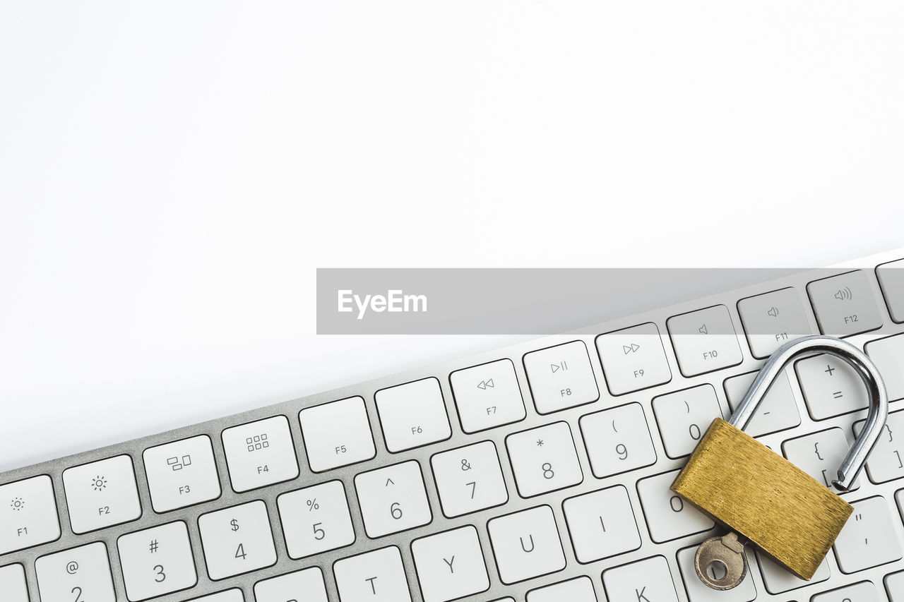 Close-up of padlock on keyboard over table