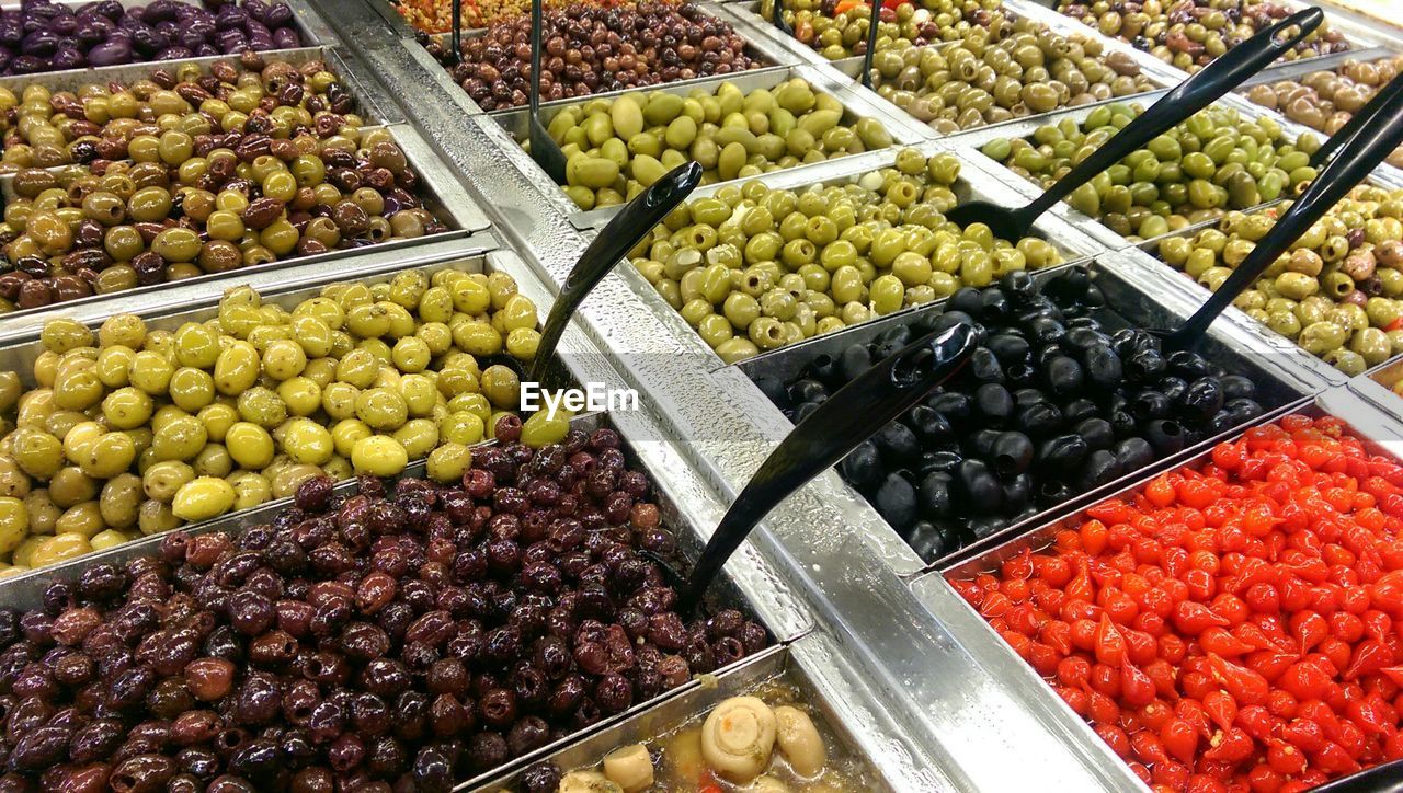 High angle view of preserved olives for sale at market stall