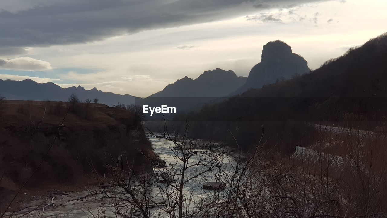 SCENIC VIEW OF MOUNTAIN AGAINST SKY DURING SUNSET