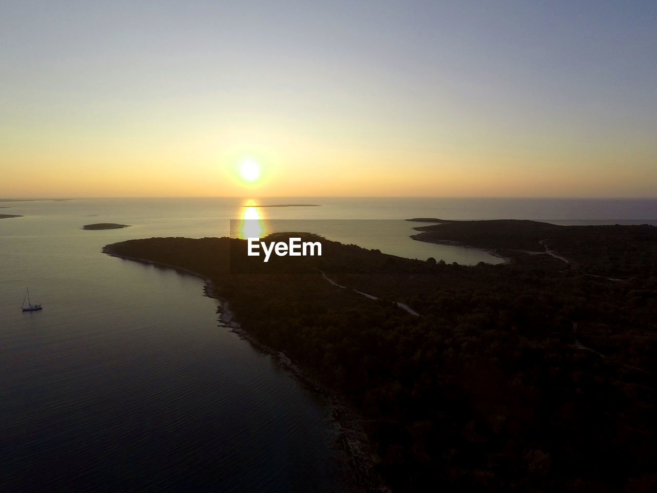 Scenic view of sea against clear sky during sunset