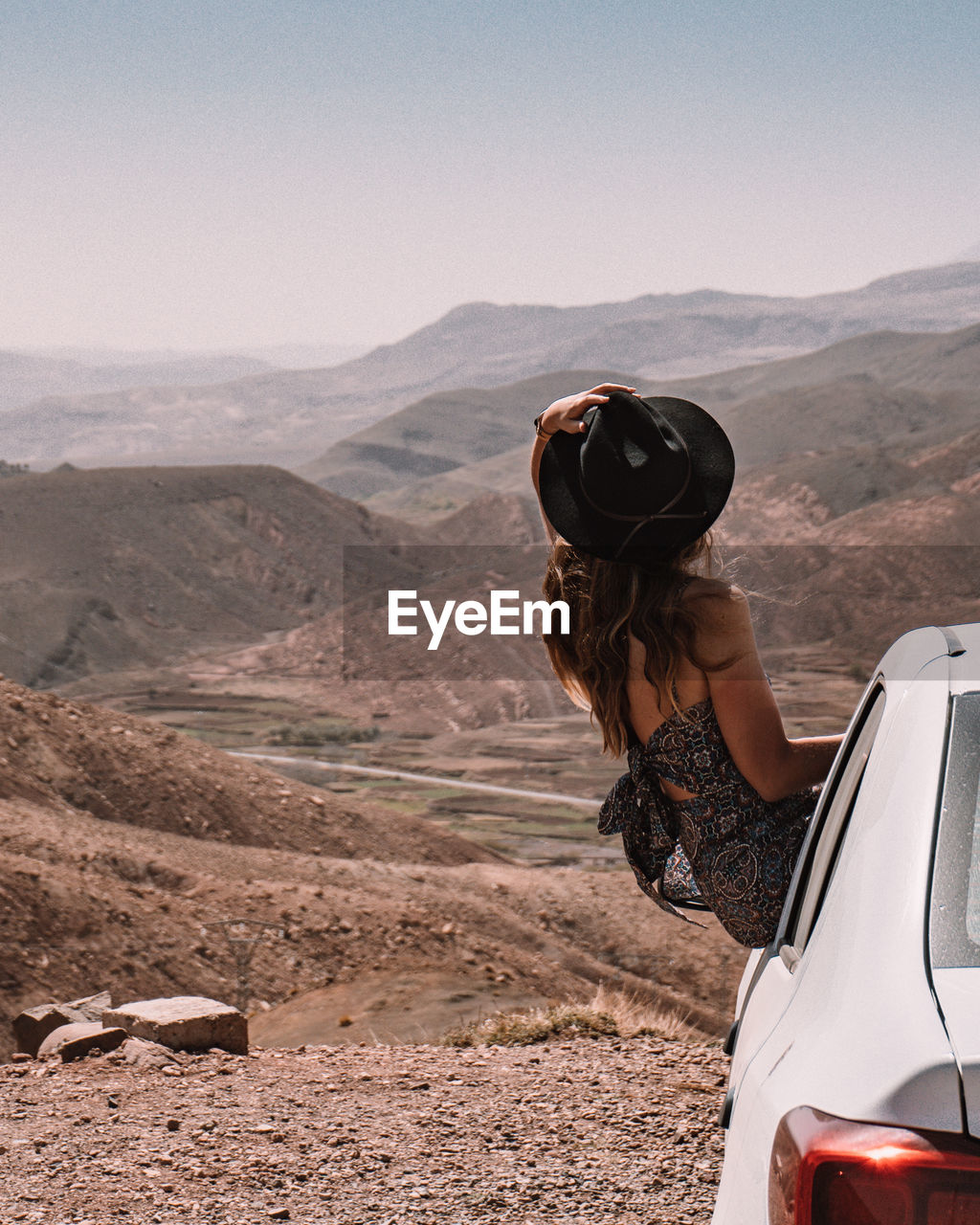 Woman on mountain road against sky