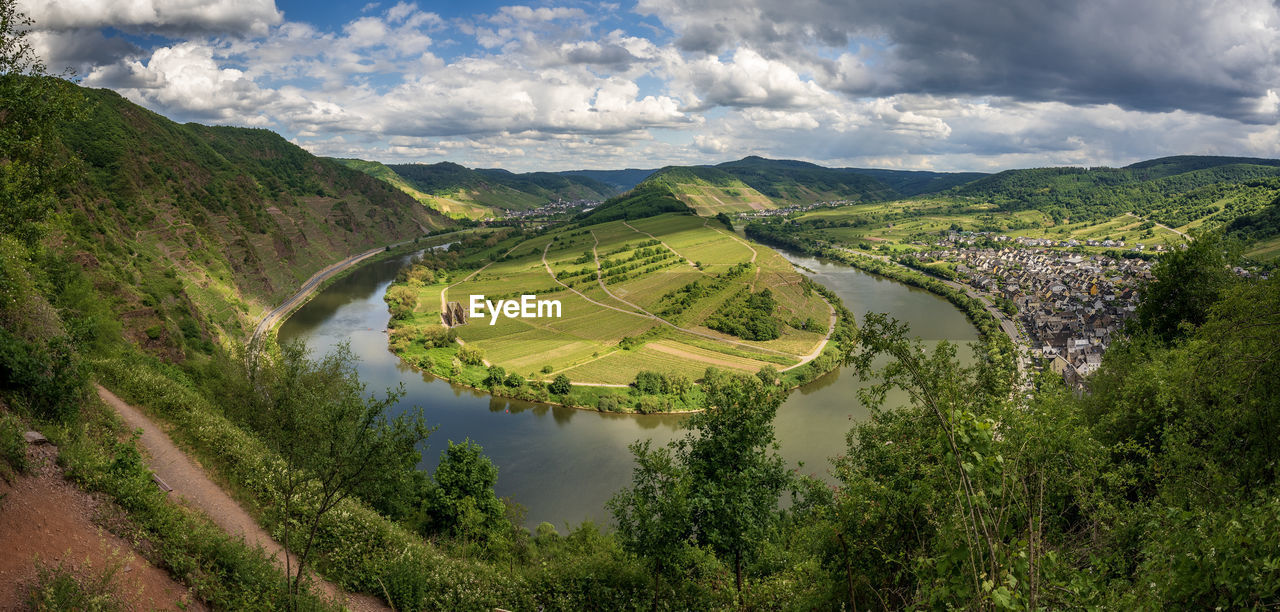 Scenic view of landscape with river against sky