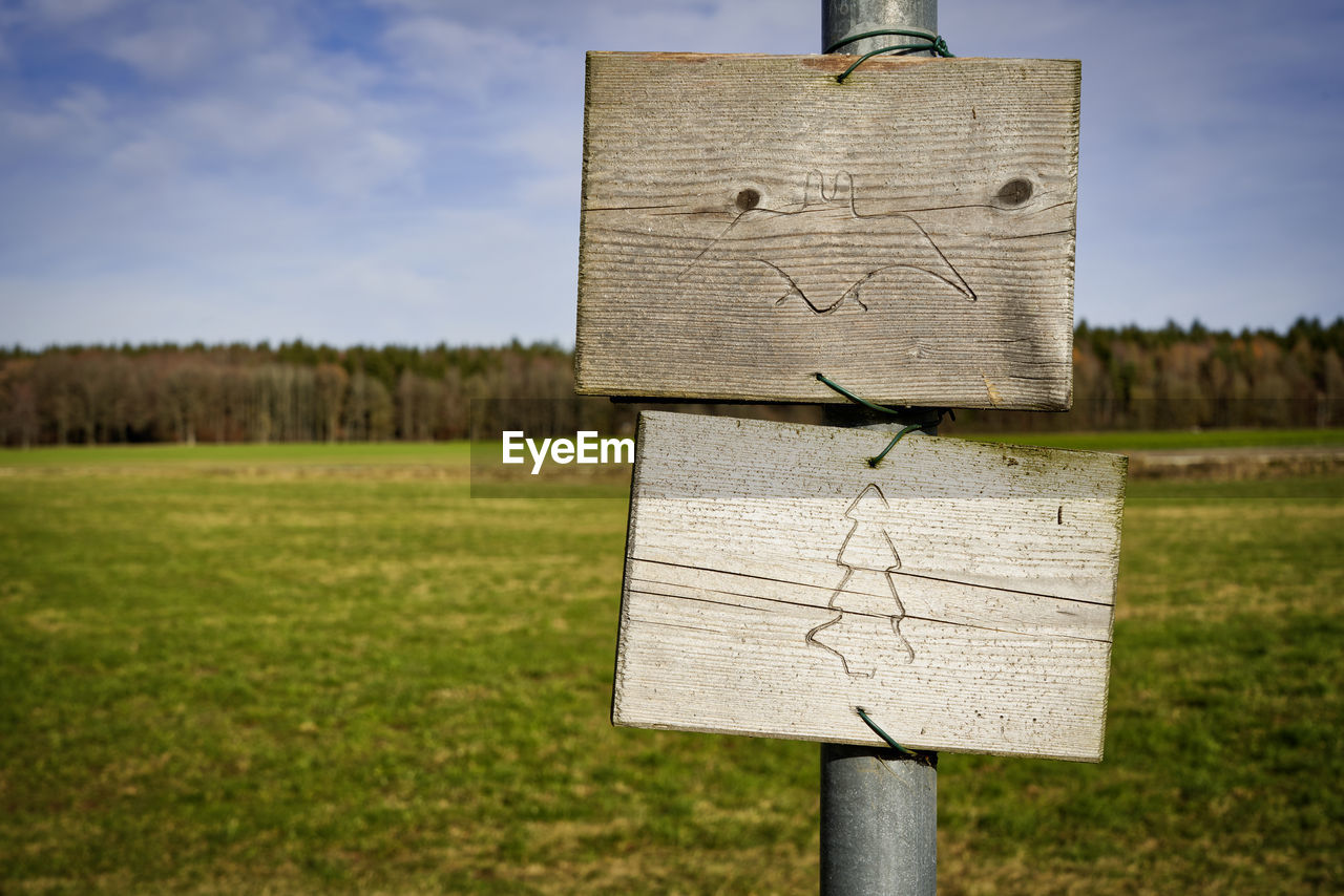 Sign close up in front of a forest