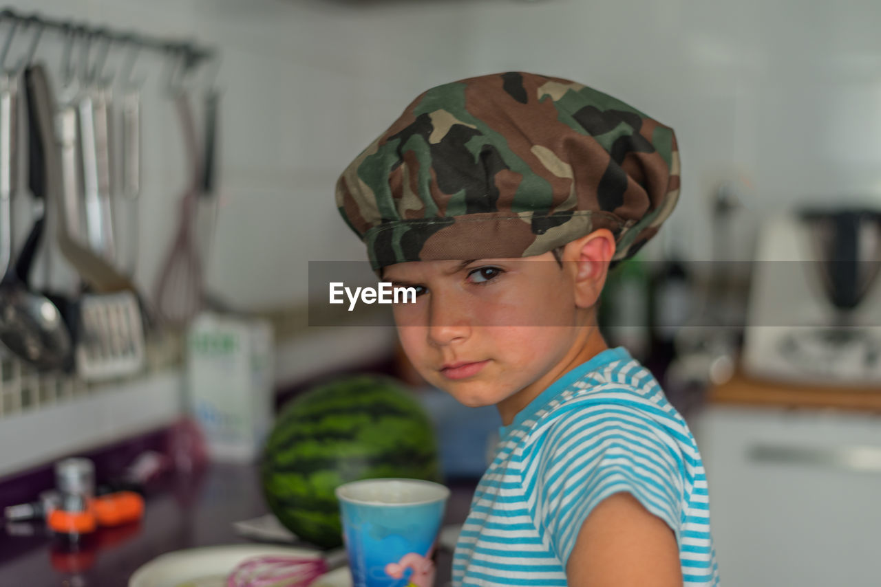 Portrait of boy wearing cap at home