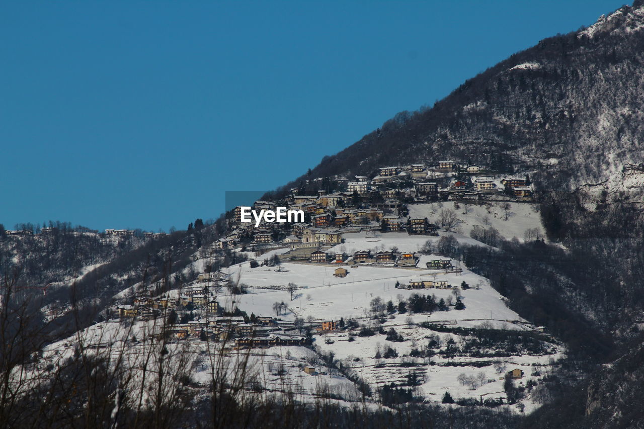 Aerial view of town against blue sky