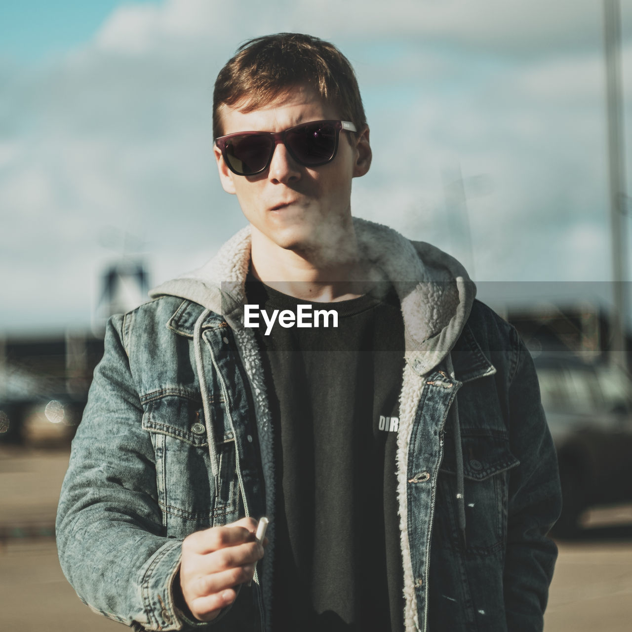 Portrait of young man wearing sunglasses standing outdoors