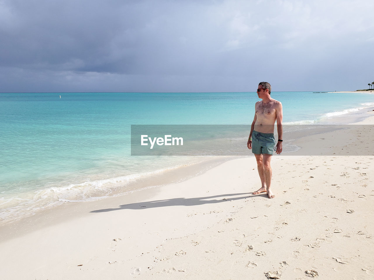 FULL LENGTH OF GIRL ON BEACH AGAINST SKY