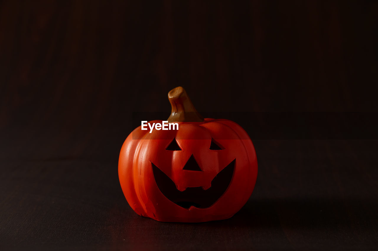 Close-up of pumpkin on table against black background