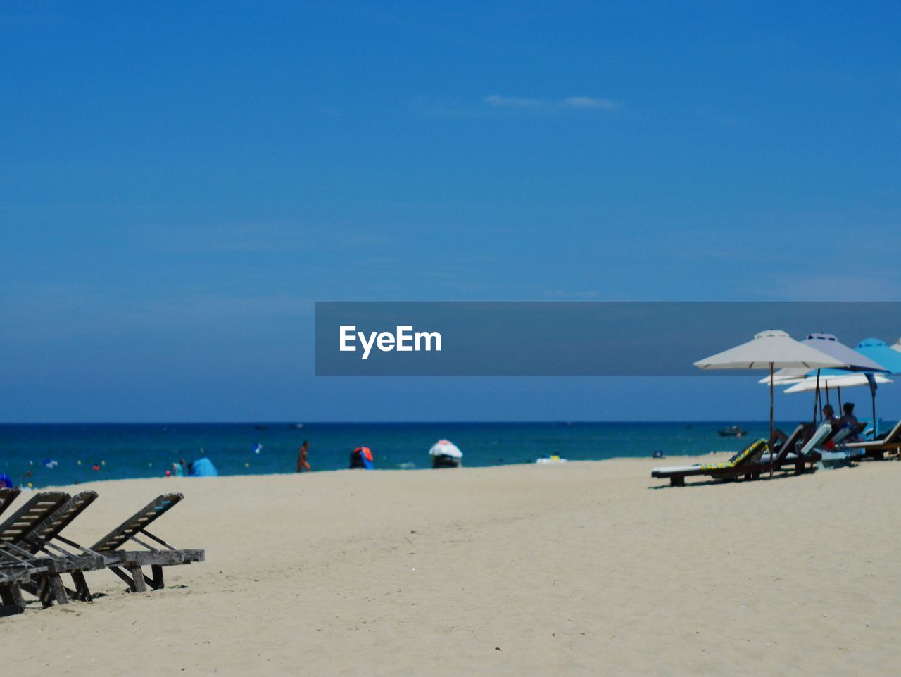 Scenic view of beach against blue sky