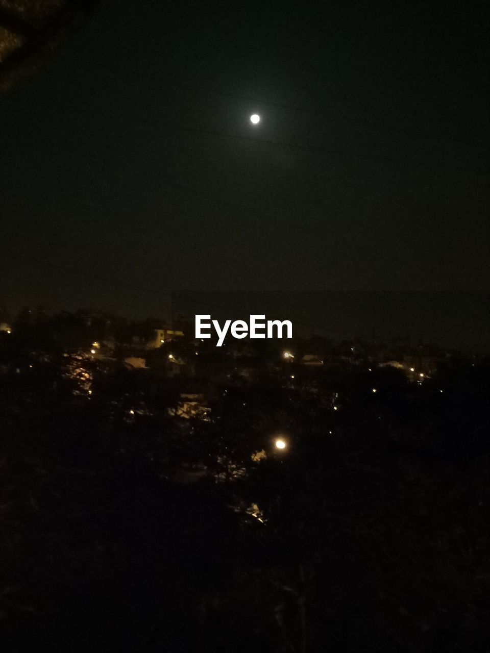 AERIAL VIEW OF ILLUMINATED CITY AGAINST SKY AT NIGHT