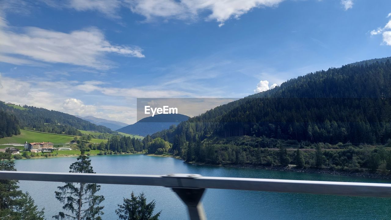 mountain, scenics - nature, tree, water, sky, beauty in nature, lake, plant, forest, nature, environment, reservoir, tranquil scene, tranquility, cloud, reflection, mountain range, pine tree, landscape, land, pinaceae, coniferous tree, no people, pine woodland, travel destinations, body of water, travel, non-urban scene, blue, idyllic, tourism, woodland, day, outdoors, vacation, trip, holiday, summer