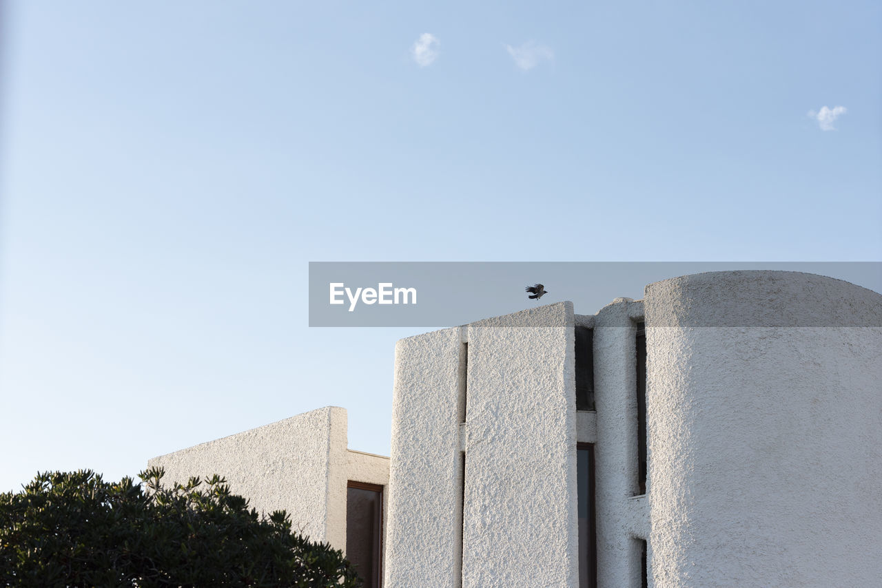 LOW ANGLE VIEW OF BUILDING AGAINST BLUE SKY