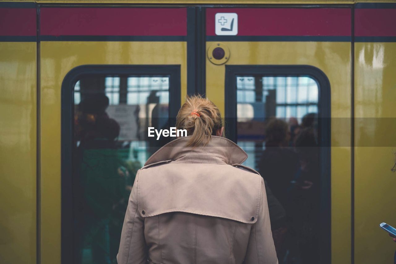 Rear view of woman in train