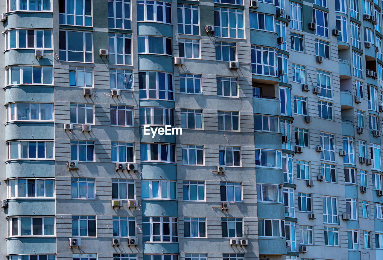 Facade of a residential building with air conditioners on the wall.