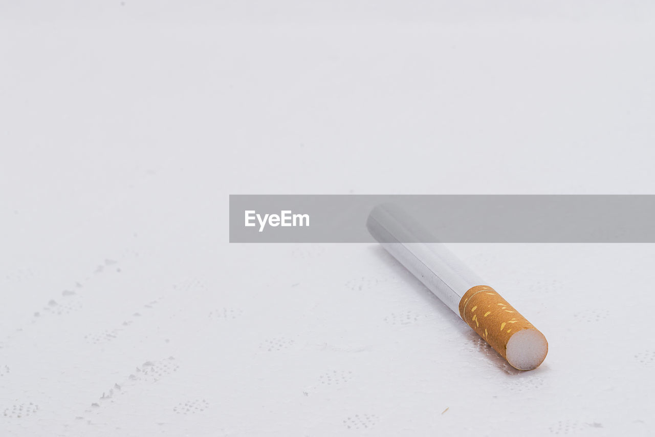 Close-up of cigarette against white background