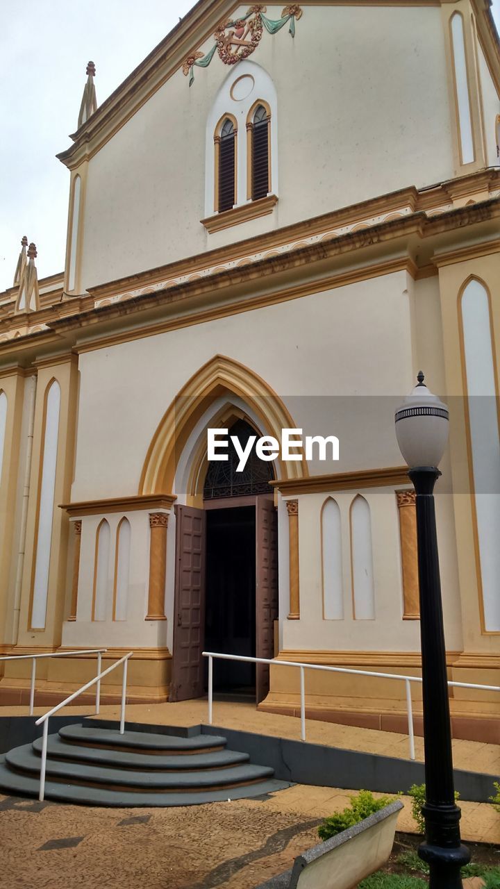 LOW ANGLE VIEW OF BUILT STRUCTURE WITH WINDOWS