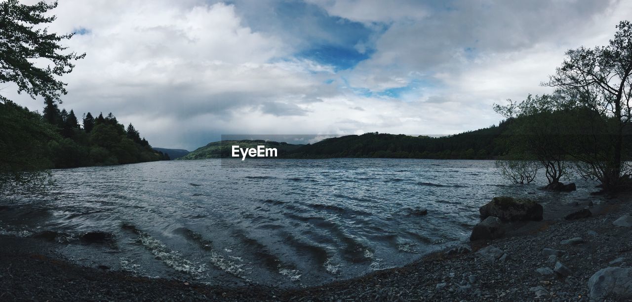 Scenic view of lake against cloudy sky