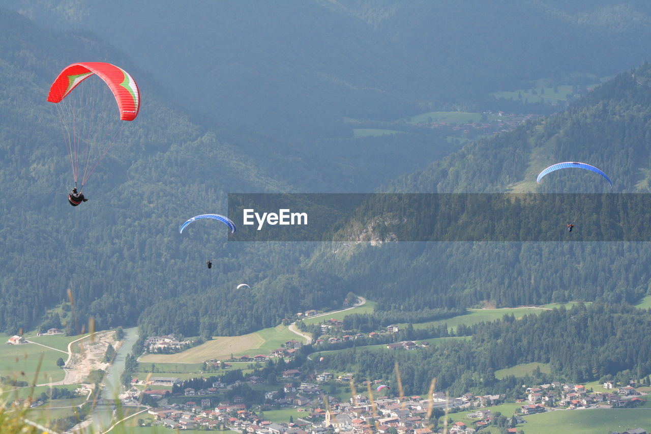 AERIAL VIEW OF HOT AIR BALLOON FLYING OVER SEA AND MOUNTAINS