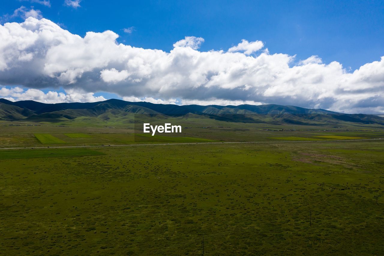 SCENIC VIEW OF LANDSCAPE AND MOUNTAINS AGAINST SKY