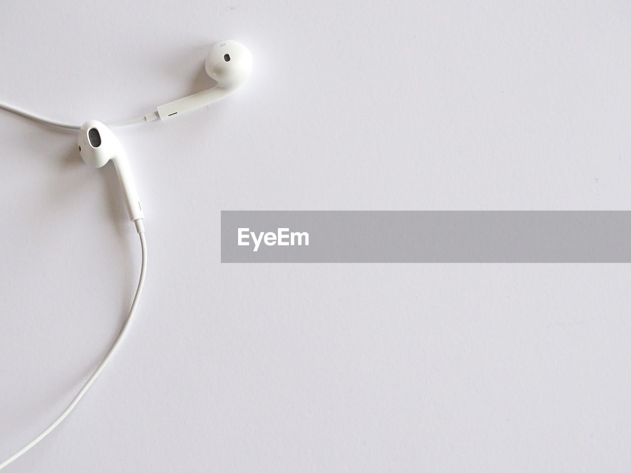 High angle view of white earphones 