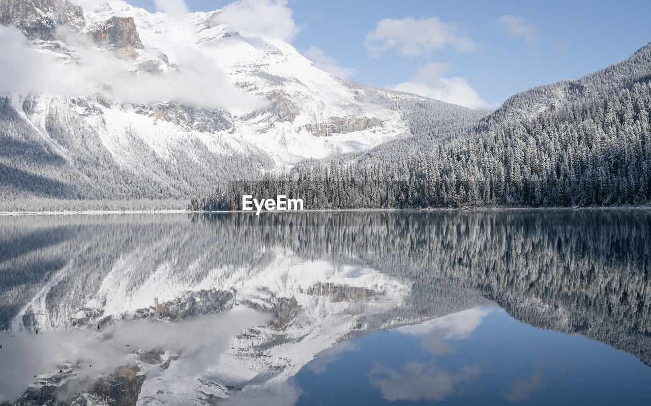 Still alpine lake reflecting its winter surroundings like a mirror, yoho n. park, canada