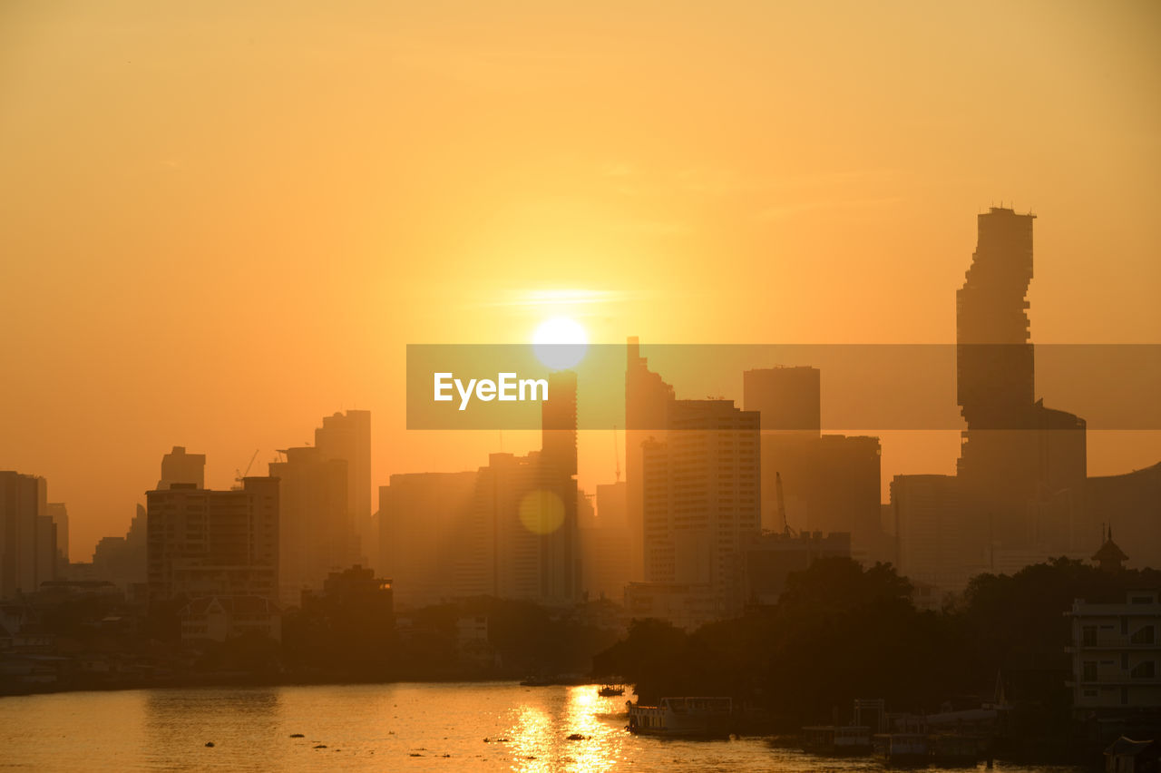 Bangkok thailand sunrise skyline silhouette view withurban office buildings.