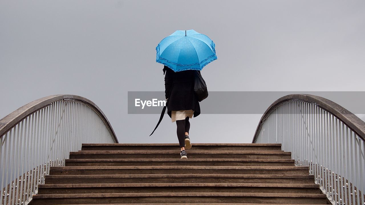 Low angle view of woman walking on staircase