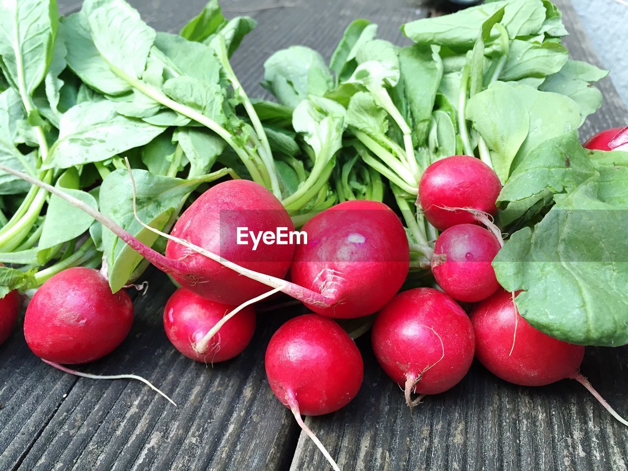 Radishes on wooden plank