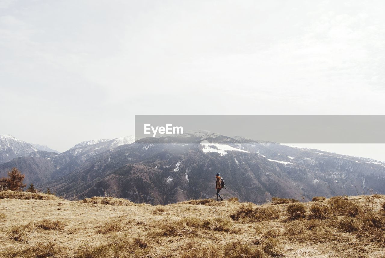 Woman hiking at monte finonchio peak against sky