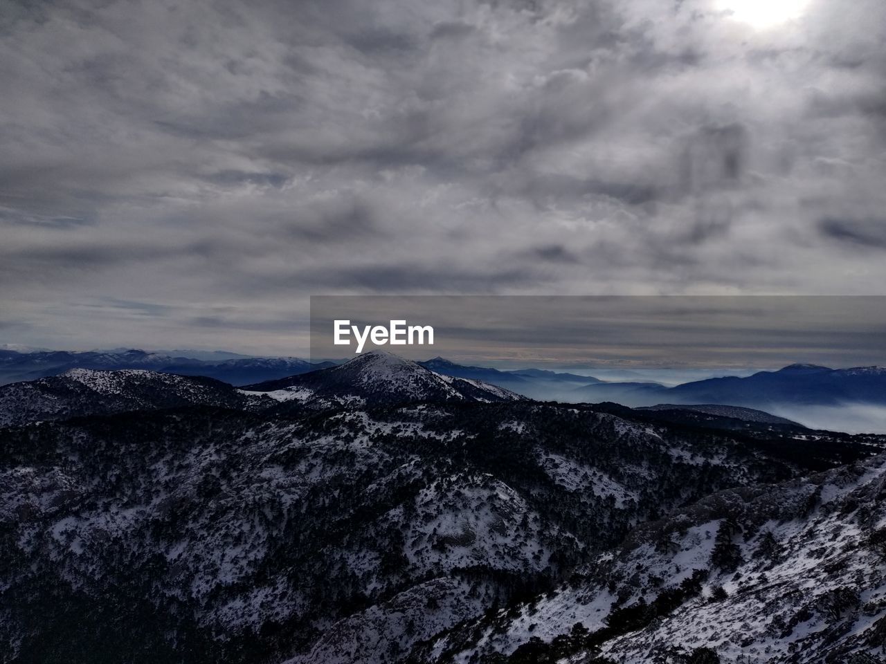 Scenic view of dramatic landscape against sky during winter