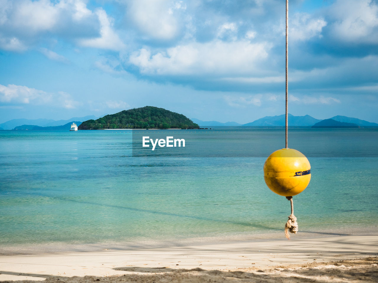 Koh kham island in peaceful turquoise sea with buoy swing. shot from koh mak island, trat, thailand.