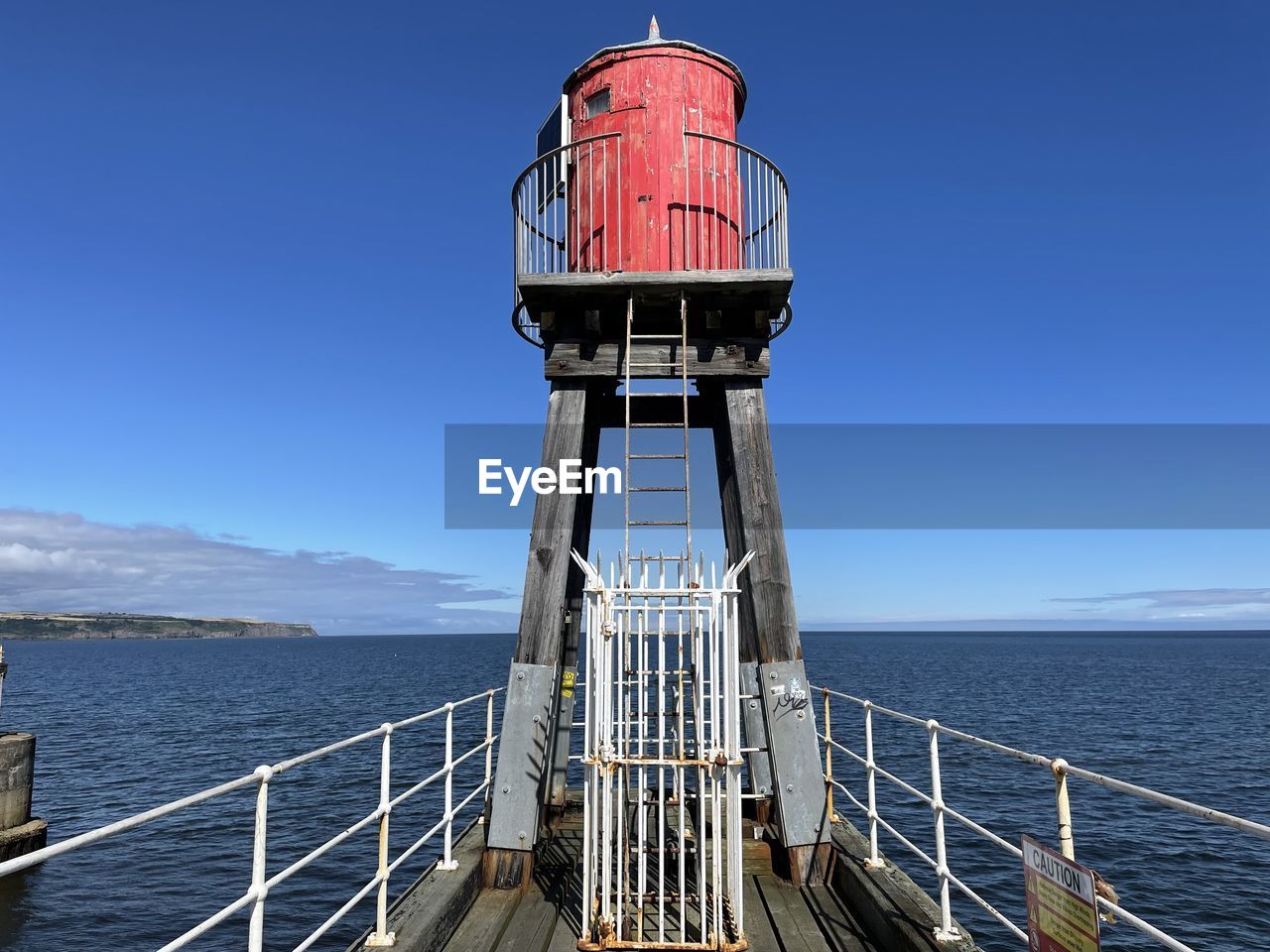 water, sea, tower, sky, lighthouse, nature, architecture, railing, security, blue, built structure, protection, clear sky, observation point, scenics - nature, transportation, no people, day, outdoors, vehicle, nautical vessel, travel, travel destinations, beauty in nature, horizon, ocean, coast, horizon over water, guidance