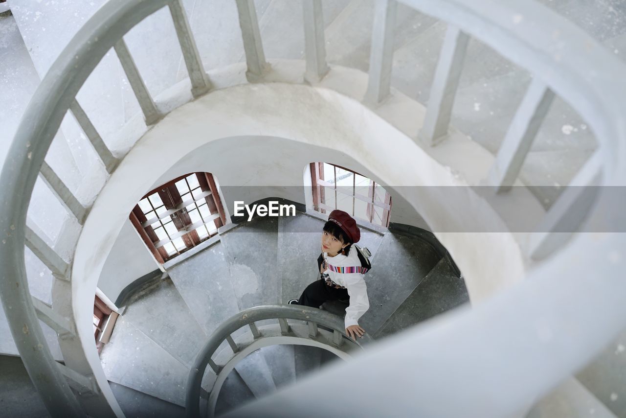 High angle view of woman standing on staircase