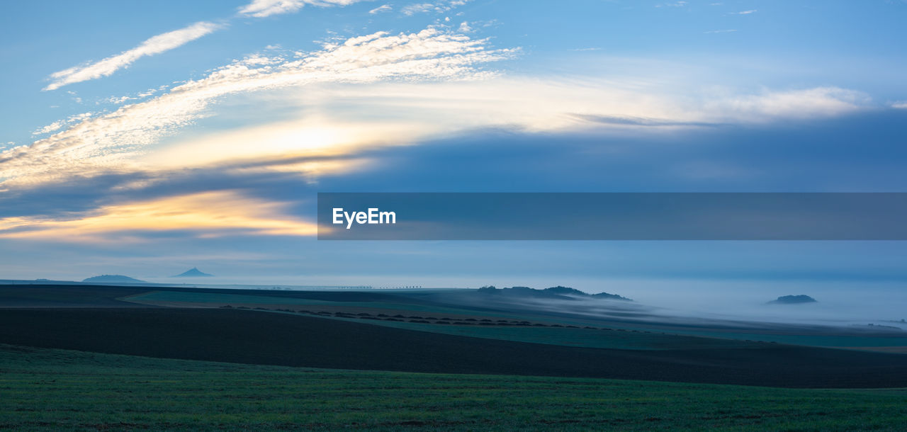 SCENIC VIEW OF LAND AGAINST SKY DURING SUNSET