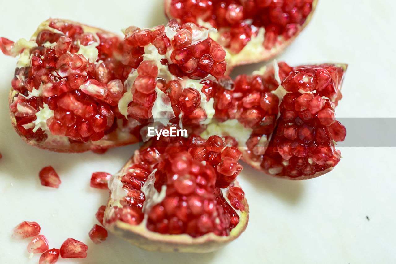 food and drink, food, plant, fruit, healthy eating, pomegranate, red, freshness, wellbeing, pomegranate seed, produce, berry, seed, no people, berries, indoors, raspberry, sweet food, close-up, still life, studio shot, high angle view, juicy