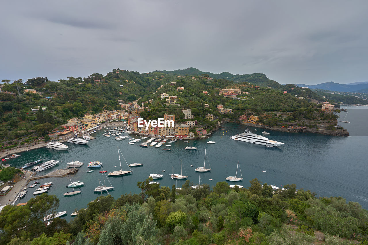 High angle view of townscape by sea against sky